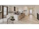 Modern kitchen with white cabinetry, stainless steel appliances, and a large center island at 11454 Stonewash St, Littleton, CO 80125