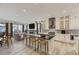 Open kitchen with island, hardwood floors, and stainless steel appliances adjacent to the living room at 11454 Stonewash St, Littleton, CO 80125