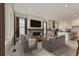Spacious living room open to kitchen, featuring hardwood floors, fireplace, and modern finishes at 11454 Stonewash St, Littleton, CO 80125