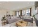 Bright living room featuring hardwood floors, plush sofas, and a fireplace at 11454 Stonewash St, Littleton, CO 80125