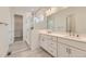 The main bathroom features dual sinks, a walk-in shower with glass doors, and tile flooring at 11454 Stonewash St, Littleton, CO 80125