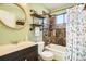 Charming bathroom with a tiled shower, industrial-style shelves, and a soothing color scheme, creating a spa-like retreat at 2210 S Oakland Way, Aurora, CO 80014