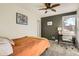 Tranquil bedroom with a ceiling fan, a soothing color palette, and a functional workspace, promoting restful sleep and focused work at 2210 S Oakland Way, Aurora, CO 80014