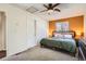 This bedroom features neutral carpet and updated light fixtures and leads to a carpeted closet at 2210 S Oakland Way, Aurora, CO 80014