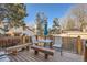 Wooden deck featuring outdoor seating with a table and bench, perfect for relaxation at 2210 S Oakland Way, Aurora, CO 80014