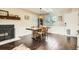 Bright dining room featuring a fireplace, hardwood floors, and a modern light fixture at 2210 S Oakland Way, Aurora, CO 80014