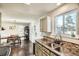 Kitchen features sleek granite countertops, a stainless steel sink, and updated cabinetry, with lots of natural light from the windows at 2210 S Oakland Way, Aurora, CO 80014