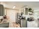 Well-equipped kitchen features ample counter space, stainless steel appliances, and a cozy breakfast nook, seamlessly blending style and functionality at 2210 S Oakland Way, Aurora, CO 80014