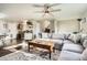 Inviting living room featuring a large sectional sofa, wood floors, and a ceiling fan at 2210 S Oakland Way, Aurora, CO 80014