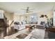 Spacious living room with hardwood floors, a large sectional sofa, and a staircase at 2210 S Oakland Way, Aurora, CO 80014