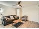 Inviting living room features comfortable seating, a stylish ceiling fan, and a calming ambiance, ideal for unwinding and socializing at 2210 S Oakland Way, Aurora, CO 80014