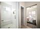 Bright bathroom featuring a tiled shower, a doorway to the main bedroom and neutral decor at 3802 Newton, Denver, CO 80211