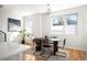 Inviting dining area features modern lighting, neutral tones, large windows, and an adjacent kitchen space at 3802 N Newton, Denver, CO 80211