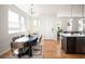 Sunlit dining area with large windows, modern light fixture, and view to the kitchen at 3802 Newton, Denver, CO 80211