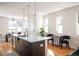 Bright kitchen featuring island with bar seating, and view to dining area and natural light at 3802 N Newton, Denver, CO 80211