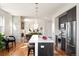 Well-lit kitchen with a fireplace, stainless steel appliances, large island, and an open concept living area at 3802 N Newton, Denver, CO 80211