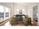 Living room with hardwood floors, a gray couch, and sliding patio doors at 3802 Newton, Denver, CO 80211