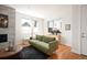 This stylish living room features an elegant fireplace, large windows, and modern decor at 3802 Newton, Denver, CO 80211