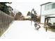 Snowy backyard with patio, gazebo and basketball hoop at 18360 E Ithaca Pl, Aurora, CO 80013