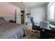 Well-lit bedroom featuring a desk, chair, and ample closet space at 18360 E Ithaca Pl, Aurora, CO 80013