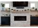 Elegant fireplace with a white stone surround and a wood mantel at 18360 E Ithaca Pl, Aurora, CO 80013