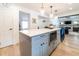 Bright kitchen with island and view into living room at 18360 E Ithaca Pl, Aurora, CO 80013