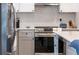 Modern kitchen with stainless steel appliances and gray cabinets at 18360 E Ithaca Pl, Aurora, CO 80013