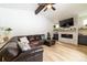 Bright living room showcasing a comfortable sectional sofa and a modern fireplace at 18360 E Ithaca Pl, Aurora, CO 80013