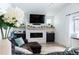 Cozy living room with fireplace and large TV at 18360 E Ithaca Pl, Aurora, CO 80013