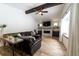 Spacious living room with a leather sectional sofa and a stone fireplace at 18360 E Ithaca Pl, Aurora, CO 80013