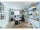 Home office with built-in shelving and hardwood floors at 18360 E Ithaca Pl, Aurora, CO 80013