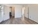 Spacious bedroom features wood-look flooring and multiple doors at 8225 Fairmount Dr # 105, Denver, CO 80247