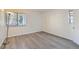 Light-filled bedroom with neutral walls and wood-look flooring at 8225 Fairmount Dr # 105, Denver, CO 80247