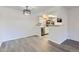 Open dining area with modern lighting and view into kitchen at 8225 Fairmount Dr # 105, Denver, CO 80247