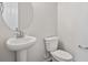 Small bathroom with pedestal sink and toilet at 24540 E 36Th Ave, Aurora, CO 80019