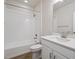 Clean bathroom with white tile, a bathtub, and a vanity with a quartz countertop at 24540 E 36Th Ave, Aurora, CO 80019