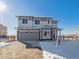 Two-story house with gray siding, stone accents, and a two-car garage at 24540 E 36Th Ave, Aurora, CO 80019