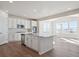 Modern kitchen with white cabinets, large island, and stainless steel appliances at 24540 E 36Th Ave, Aurora, CO 80019