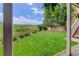 Lush backyard featuring vibrant green lawn, landscaping, community view, and stair access for a perfect outdoor oasis at 10609 Chadsworth Ln, Highlands Ranch, CO 80126