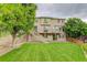 Expansive backyard featuring a well-maintained lawn, two-story deck, and mature shade trees at 10609 Chadsworth Ln, Highlands Ranch, CO 80126