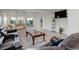 Finished basement boasts open layout, foosball table, comfy seating, and natural light from the sliding glass door at 10609 Chadsworth Ln, Highlands Ranch, CO 80126