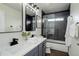 A modern bathroom features dual sinks, new fixtures, and an updated shower at 10609 Chadsworth Ln, Highlands Ranch, CO 80126