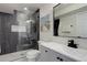 Modern bathroom with glass-enclosed shower, sleek fixtures, neutral color palette, and white tile at 10609 Chadsworth Ln, Highlands Ranch, CO 80126