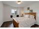 A bedroom features a wooden frame bed, neutral decor, and a window with a view at 10609 Chadsworth Ln, Highlands Ranch, CO 80126