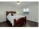 Bedroom features a wooden frame bed, hardwood floors, and an inviting window seat at 10609 Chadsworth Ln, Highlands Ranch, CO 80126