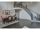 Dining room features an ornate staircase, high ceilings, and a modern light fixture at 10609 Chadsworth Ln, Highlands Ranch, CO 80126