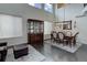 Bright dining room featuring dark wood floors, high ceilings, and a china cabinet at 10609 Chadsworth Ln, Highlands Ranch, CO 80126