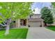 Charming two-story home featuring a well-manicured lawn and welcoming front porch at 10609 Chadsworth Ln, Highlands Ranch, CO 80126