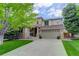 Charming two-story home featuring a well-manicured lawn and welcoming front porch at 10609 Chadsworth Ln, Highlands Ranch, CO 80126