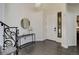 Bright foyer featuring dark wood floors, white walls, and an elegant black staircase at 10609 Chadsworth Ln, Highlands Ranch, CO 80126